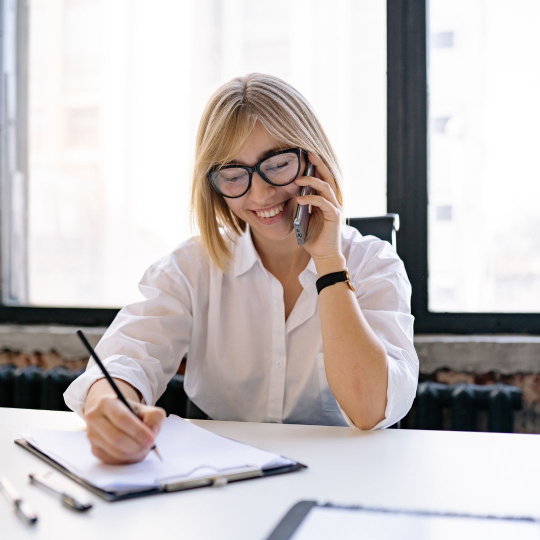 a smiling woman on the phone