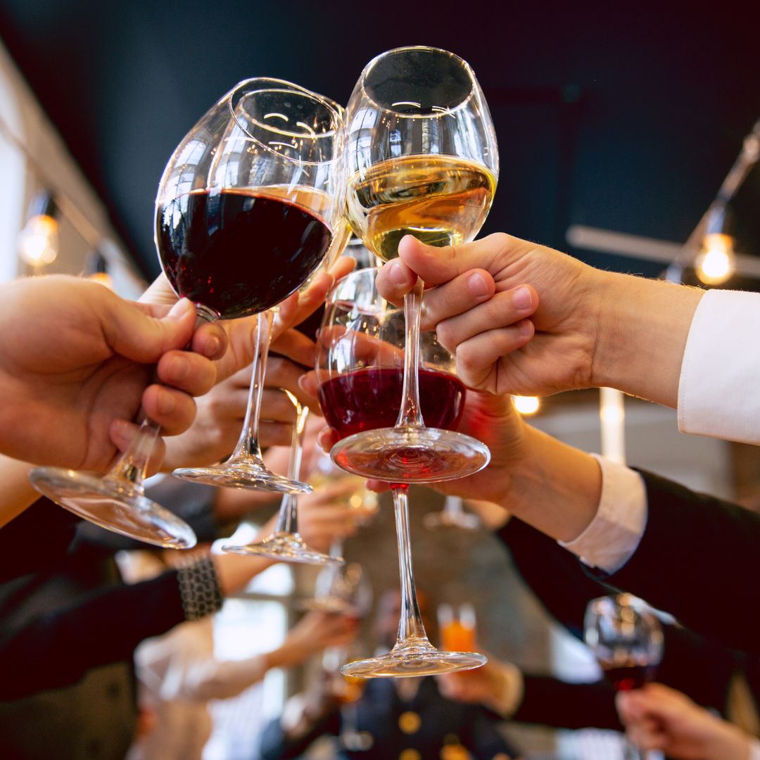 businesspeople clinking wine glasses together