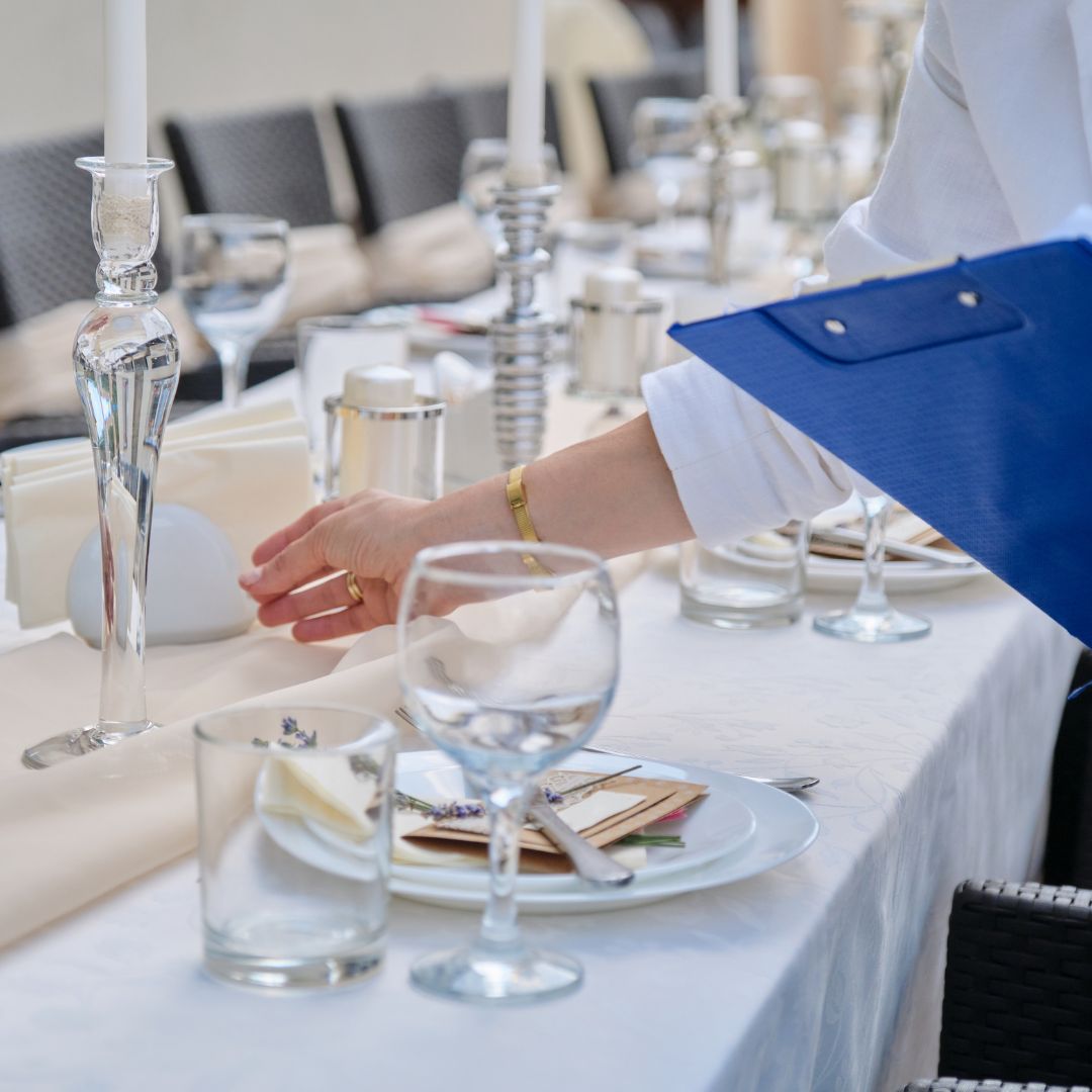 a person quality checking a table setting