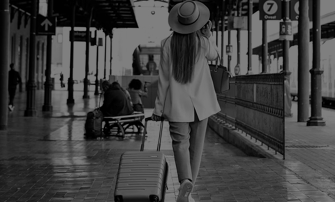 a woman on the phone pulling luggage