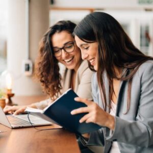 A travel director smiling with a client during a meeting