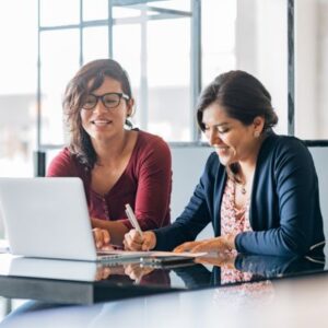 A travel director and client looking at a laptop together