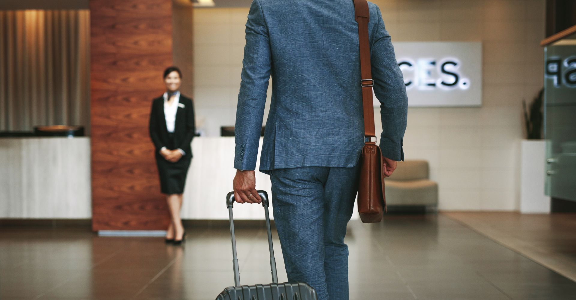 A businessman arriving at a hotel with his luggage