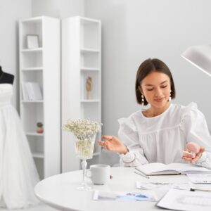 Wedding coordinator sits at a desk